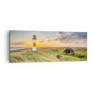 Cuadro sobre lienzo - Impresión de Imagen - Un faro con prados y casas al sol al fondo. - 140x50cm - Entre las olas - Decoración de pared moderna para salón y dormitorio ARTTOR