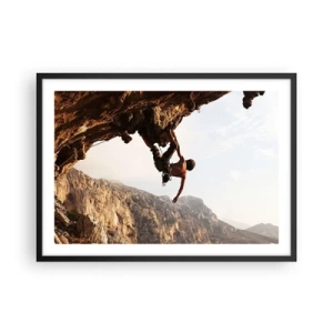 Póster en marco negro - Un escalador en un acantilado escarpado en las montañas bajo el sol. - 70x50cm - Un mundo en la roca - Decoración de pared moderna para salón y dormitorio ARTTOR