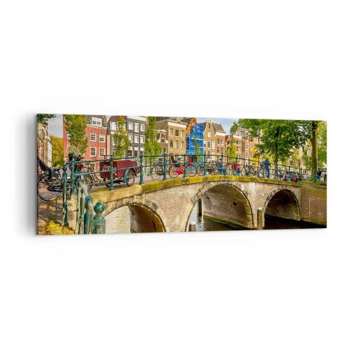 Cuadro sobre lienzo - Impresión de Imagen - Un pintoresco canal con un puente en Ámsterdam. - 140x50cm - Primavera en el canal - Decoración de pared moderna para salón y dormitorio ARTTOR