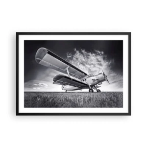 Póster en marco negro - Un avión contra un cielo dramático en blanco y negro. - 70x50cm - El vagamundo alado - Decoración de pared moderna para salón y dormitorio ARTTOR