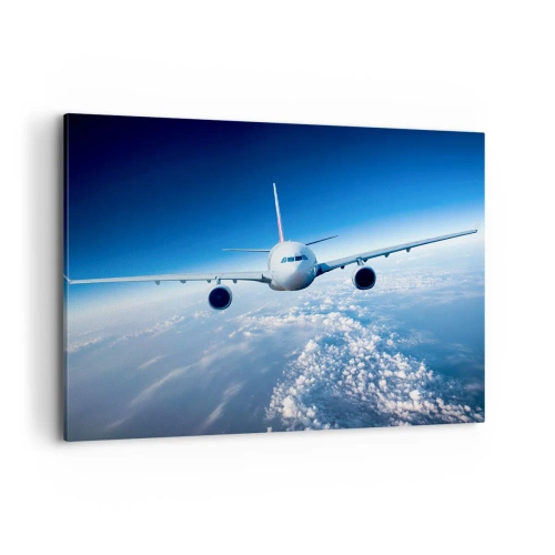 Cuadro sobre lienzo - Impresión de Imagen - Un avión volando sobre las nubes contra un cielo azul. - 100x70cm - Vuelo porque quiero - Decoración de pared moderna para salón y dormitorio ARTTOR