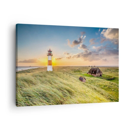 Cuadro sobre lienzo - Impresión de Imagen - Un faro con prados y casas al sol al fondo. - 70x50cm - Entre las olas - Decoración de pared moderna para salón y dormitorio ARTTOR