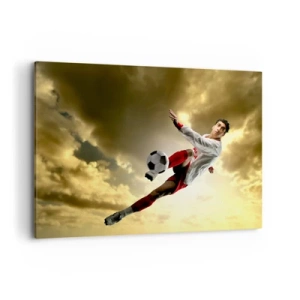Cuadro sobre lienzo - Impresión de Imagen - Un jugador de fútbol en un salto dinámico pateando el balón contra el cielo. - 100x70cm - El cielo del fútbol - Decoración de pared moderna para salón y dormitorio ARTTOR