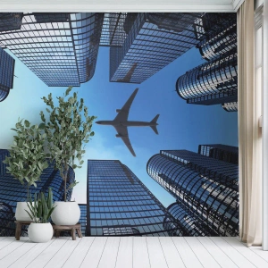 Fotomural Premium Sand - Rascacielos modernos y un avión volando en el cielo. - 100x70cm - La vista desde el abismo de cristal - Decoración de pared moderna para salón y dormitorio ARTTOR