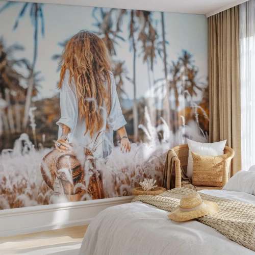 Fotomural Premium Sand - Una mujer entre la hierba frente a un paisaje bordeado de palmeras. - 100x70cm - Nacida en el plumón de la Tierra - Decoración de pared moderna para salón y dormitorio ARTTOR