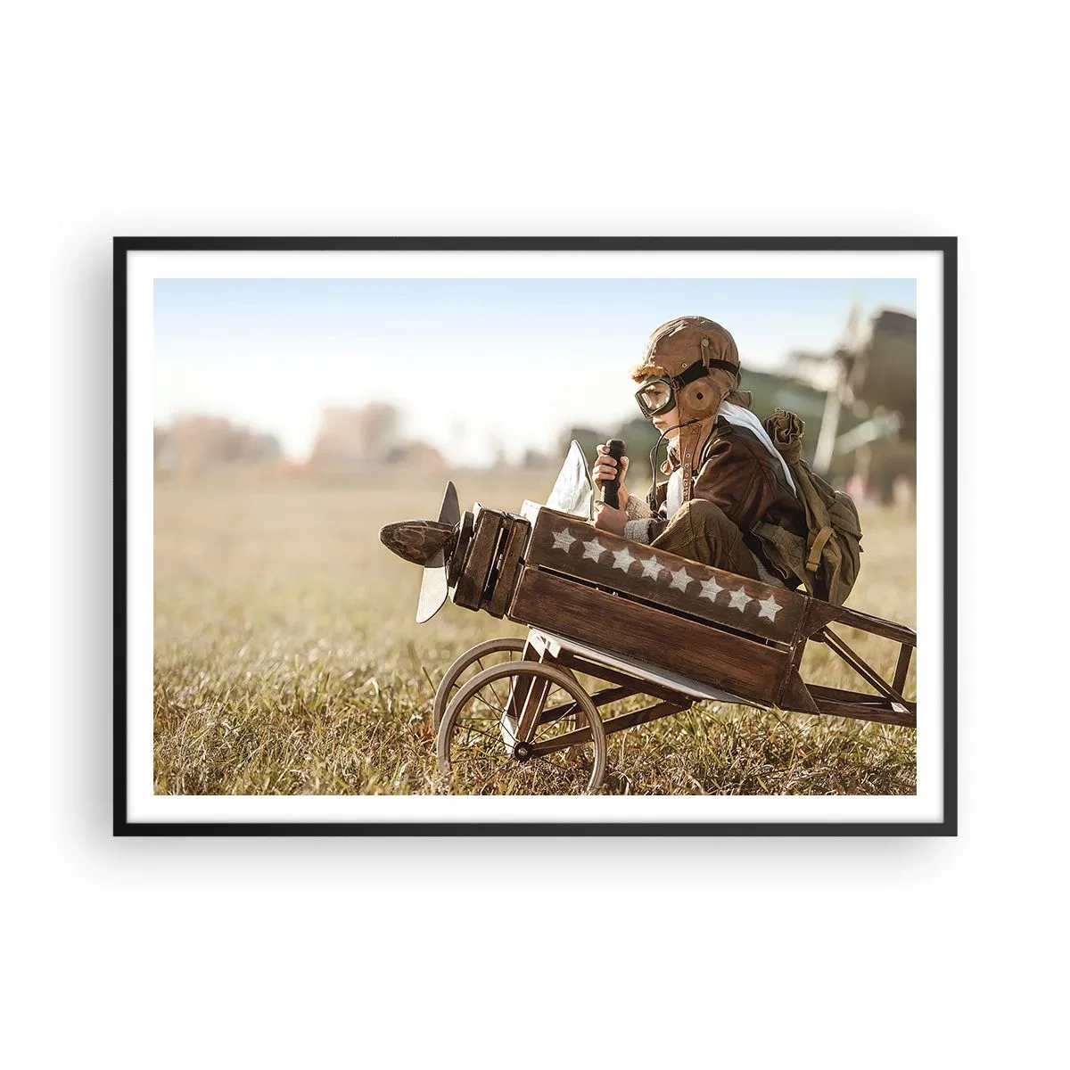 Póster en marco negro - Un niño en un avión de juguete con un campo al fondo. - 100x70cm - Despegue hacia un sueño - Decoración de pared moderna para salón y dormitorio ARTTOR
